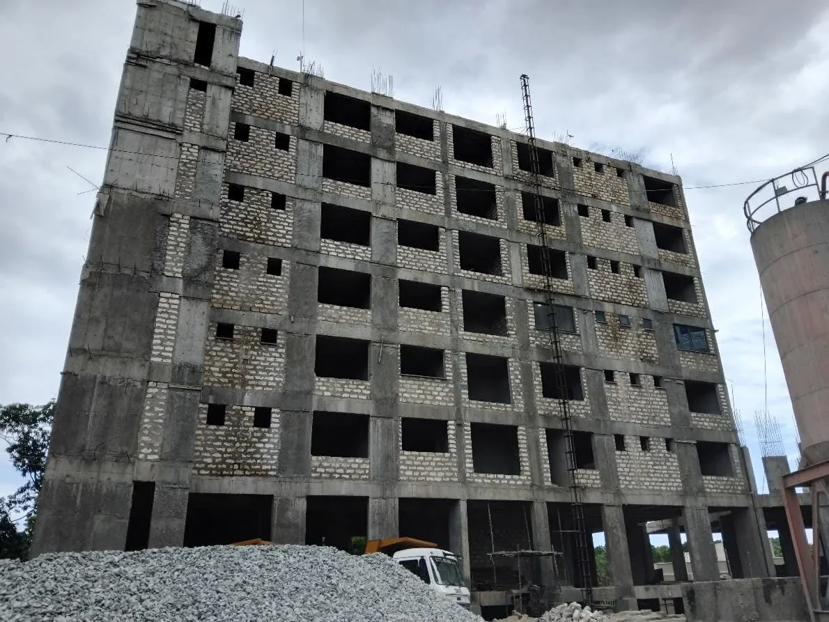Aquavista Residences, Nyali, under construction, with block infill walls and window openings beside a tall concrete cylinder