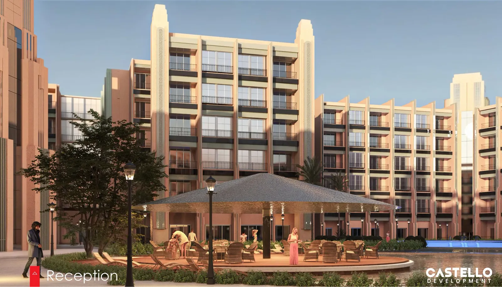 Outdoor seating area with a large sunshade structure surrounded by a pond and multi-story apartment buildings during sunset.
