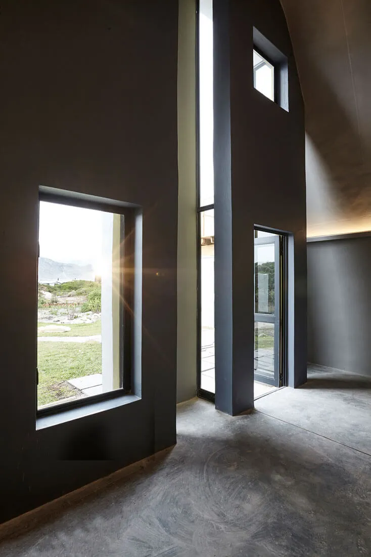 Contemporary interior with large windows and minimalist architecture.