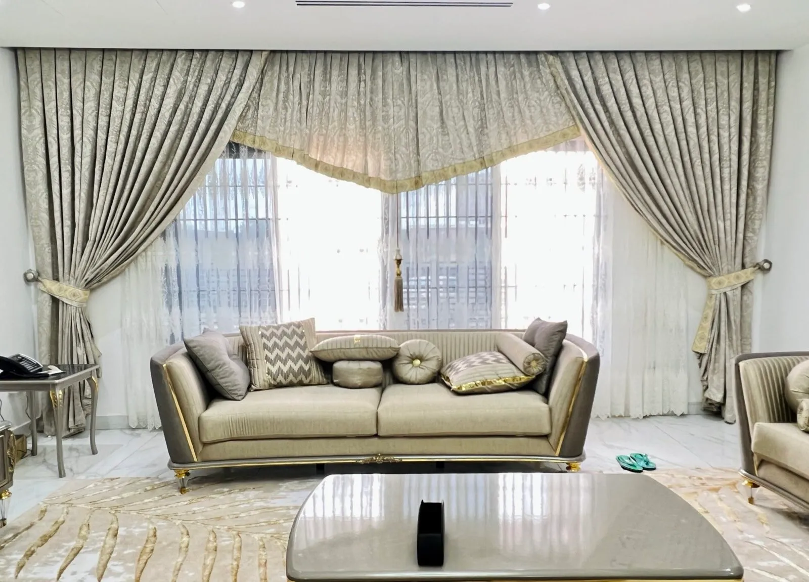 Remodelled living room of the Stone House with full-height curtains