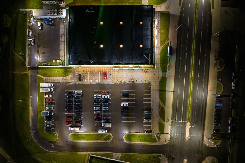 aerial-night-view-on-large-open-air-parking-lot-fo-2023-11-27-04-57-26-utc