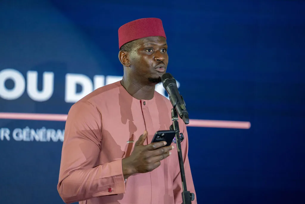 Homme en tenue traditionnelle parlant au micro